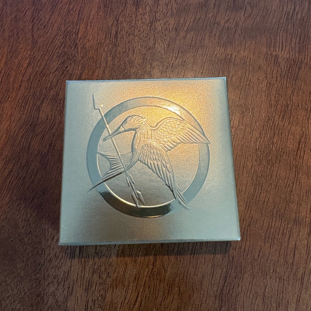 Storybook CosmeticsRevolution World Of Hunger Games Pressed Powder Compact.